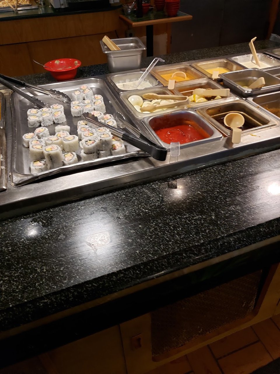 Chinese buffet dishes on a menu board